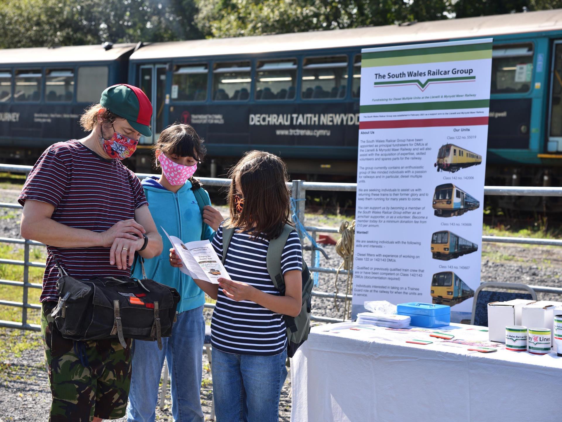Visitors check the timetable at an event