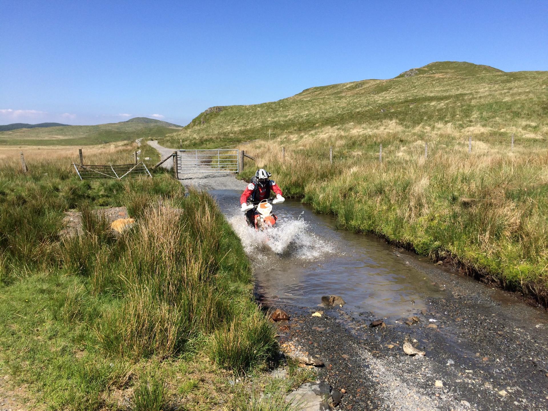 Motorcyclist fording a stream