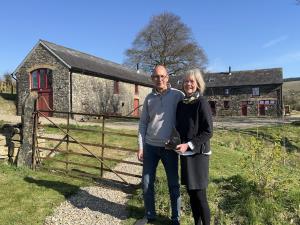 A view of the owners in front of the barn