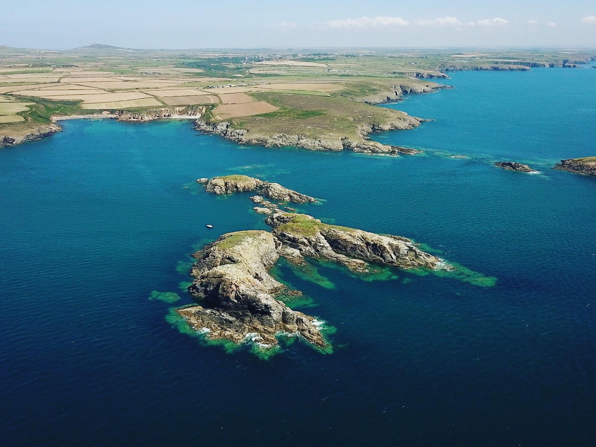 Aerial view looking into Porthllisky at high tide
