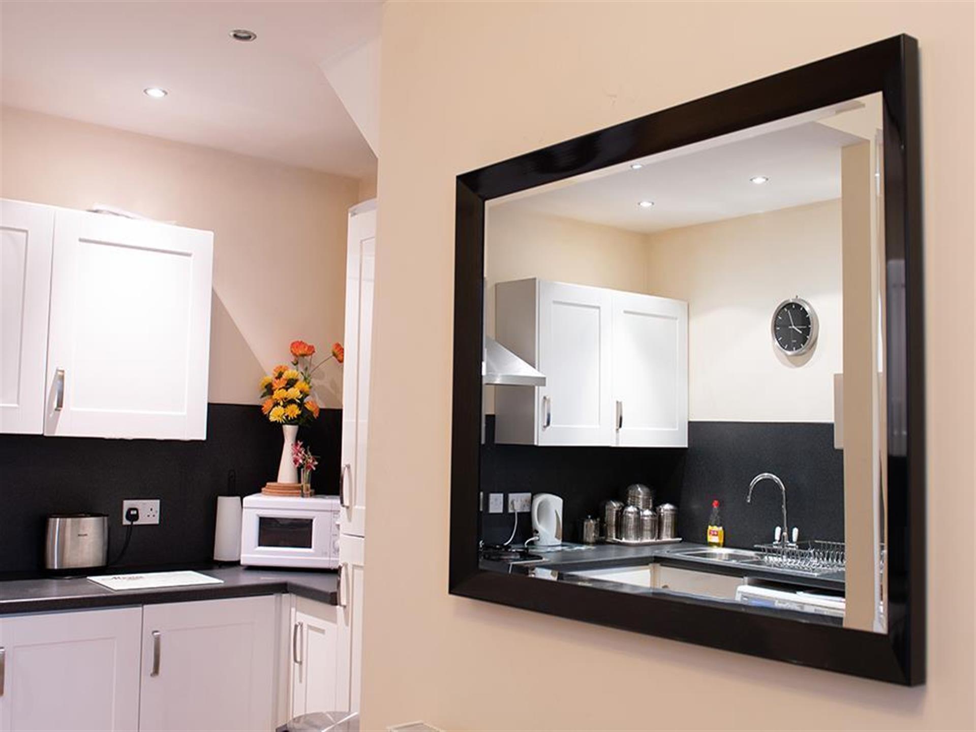 Honeydew kitchen-diner reflected in a mirror