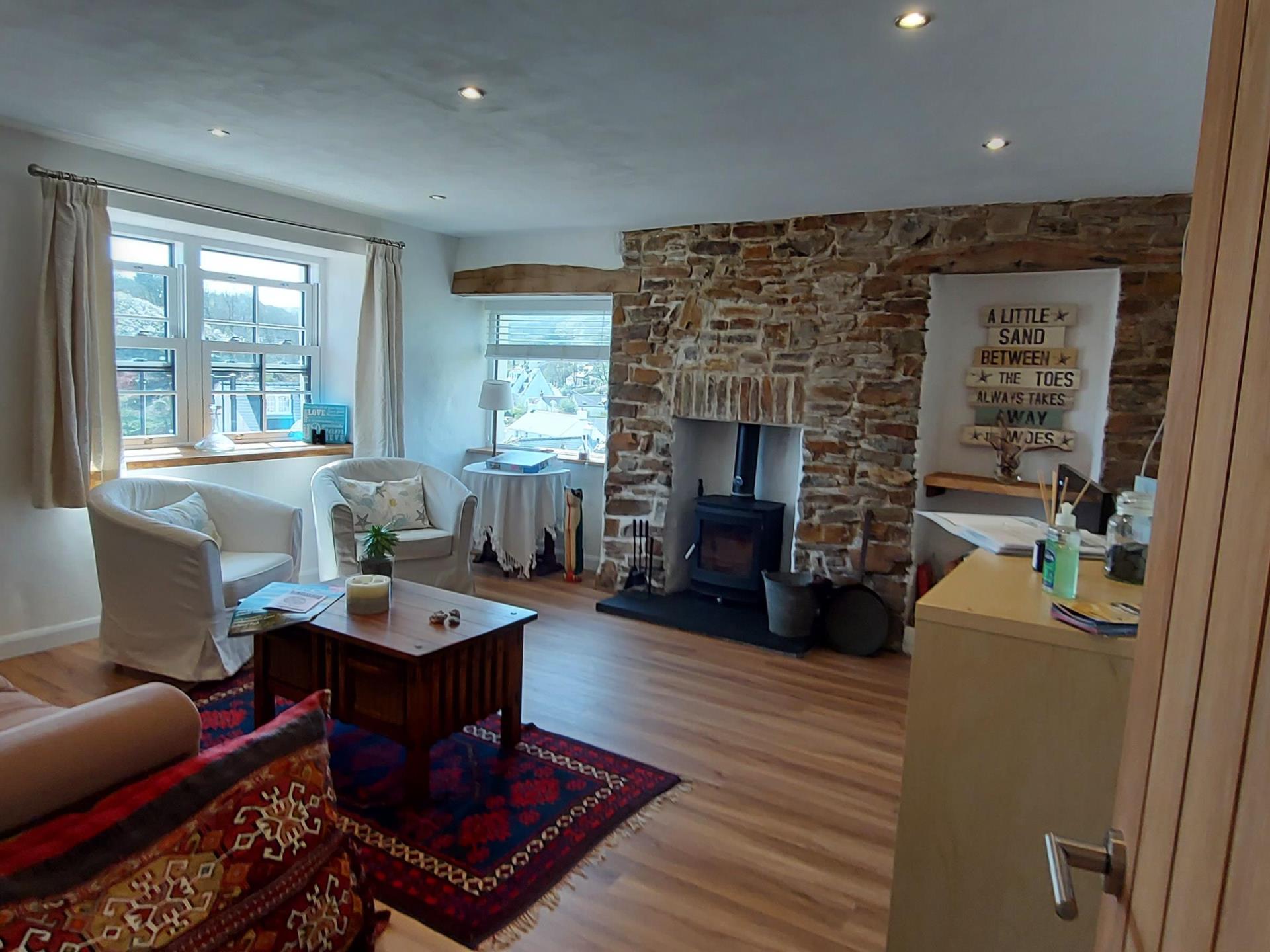 A home to home lounge with a wood burner.
