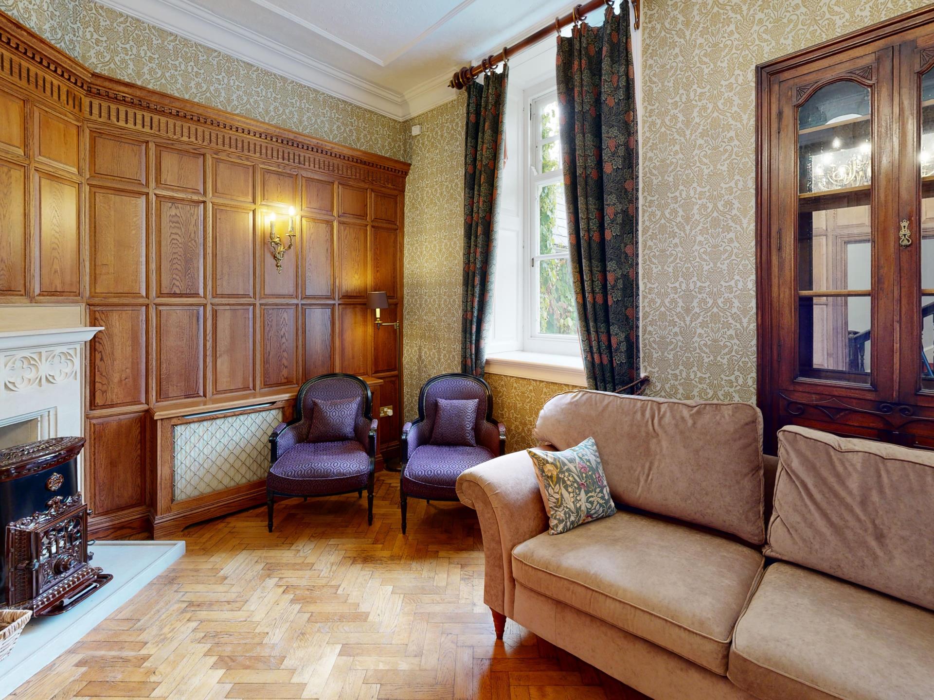Period Lounge with Wood Paneling and Fireplace