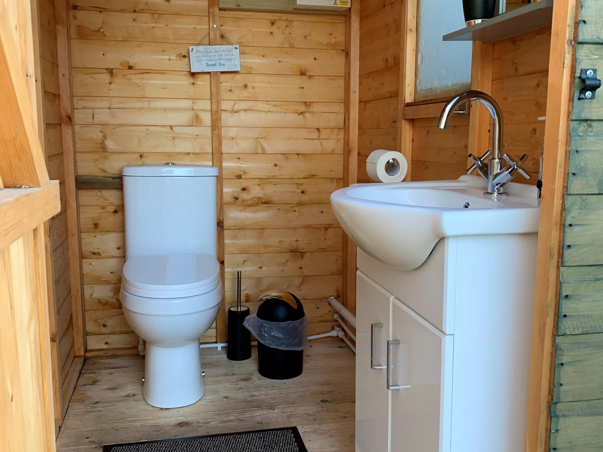 Your own flushing toilet and basin with hot water