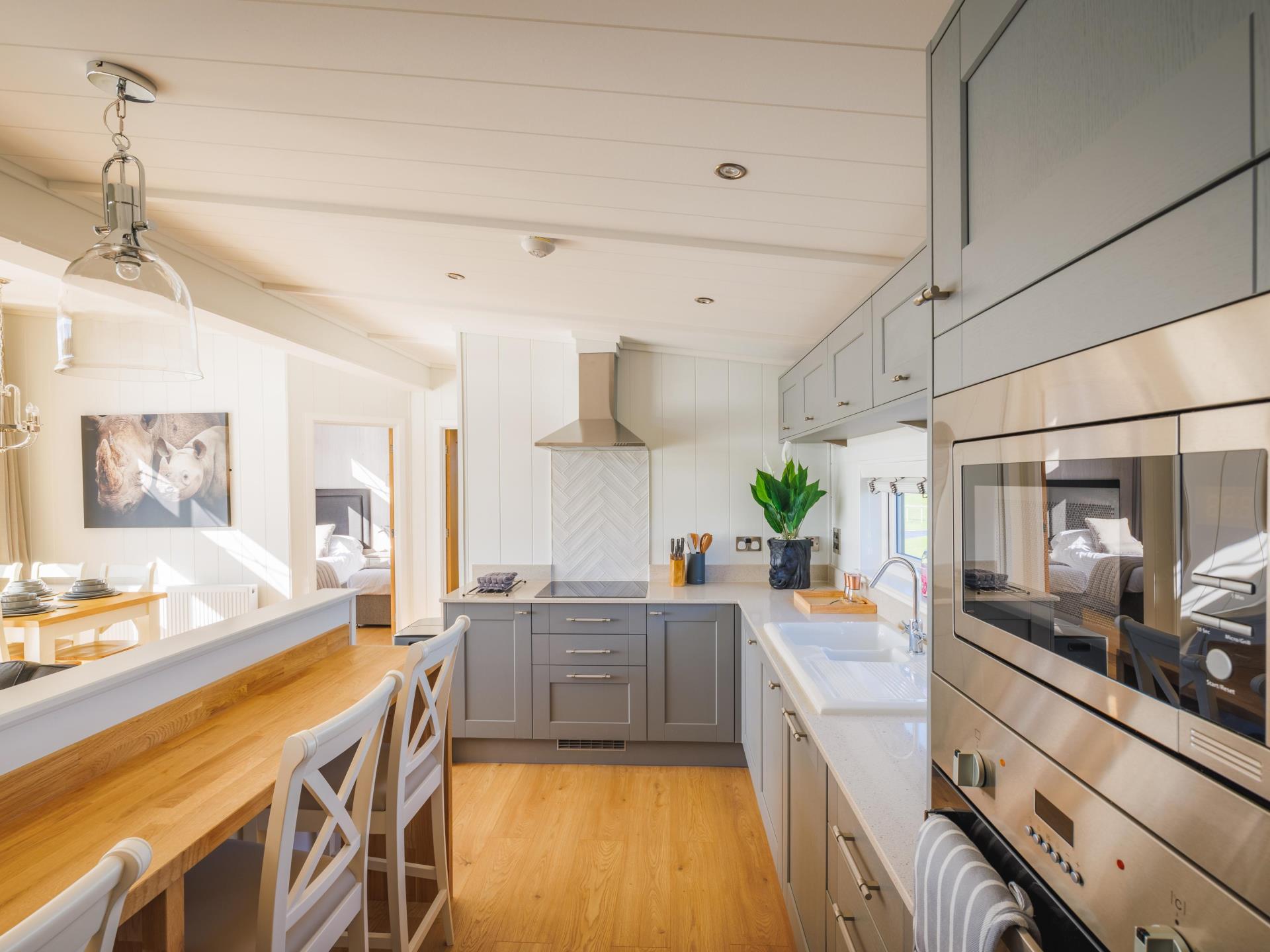 Fitted kitchen in rhino-themed lodge at Folly Farm