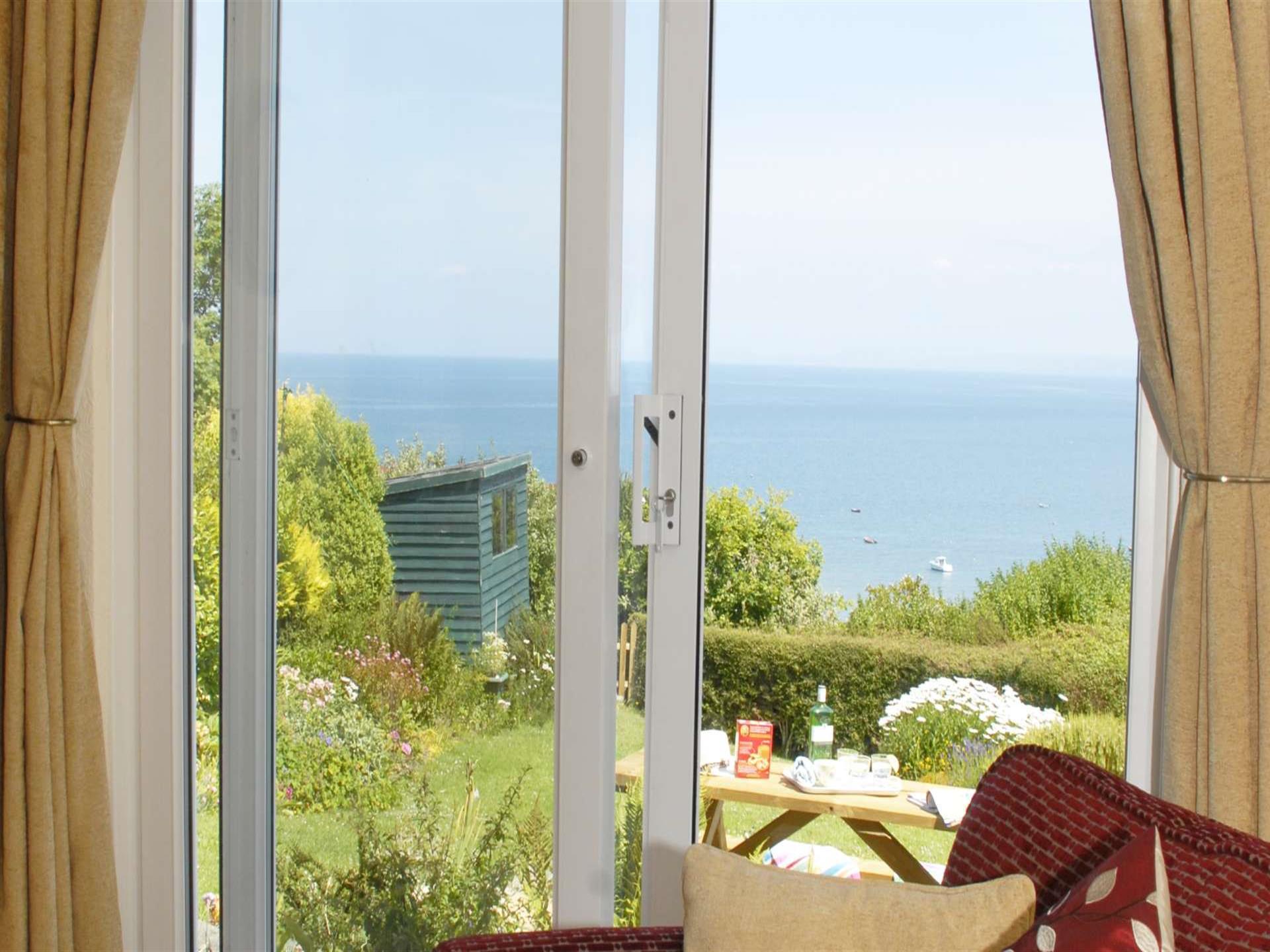 Views over the garden to the sea from the lounge
